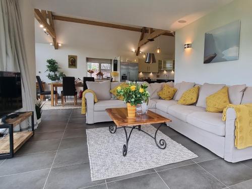 a living room with a white couch and a table at Mow Barton in Wells