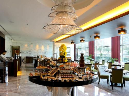 a restaurant with a buffet in the middle of a room at Cosmos Living Delightful Studio with Balcony in Dubai