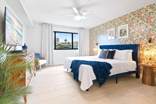 a bedroom with a bed and a ceiling fan at Sandcastles 413 in Cocoa Beach