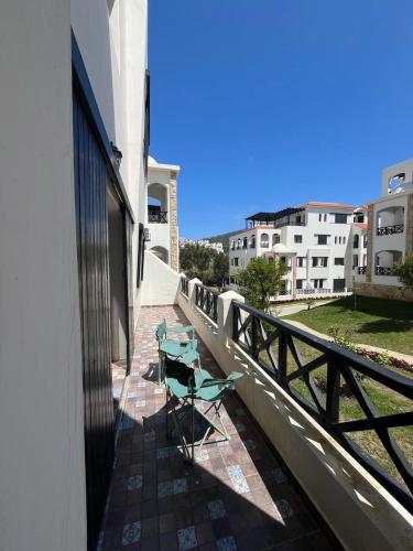 a couple of chairs sitting on a balcony at Appartement lilac's garden in Tetouan