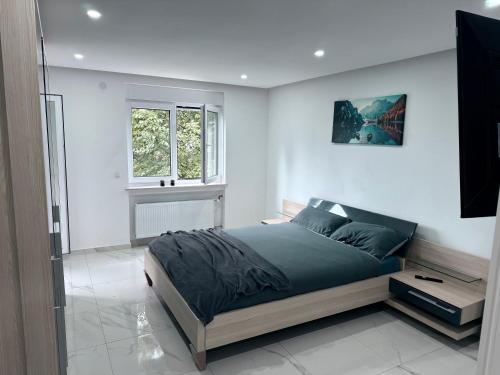 a bedroom with a bed and a window at Ferien- & Wellneswohnung mit privater Sauna und Whirlpool in Gelnhausen