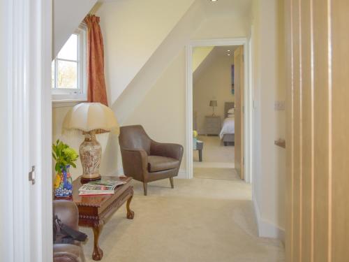 a living room with a chair and a table at Puxton Lodge in Fordwich