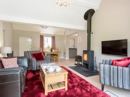 a living room with couches and a fire place at Canal View in Ellesmere
