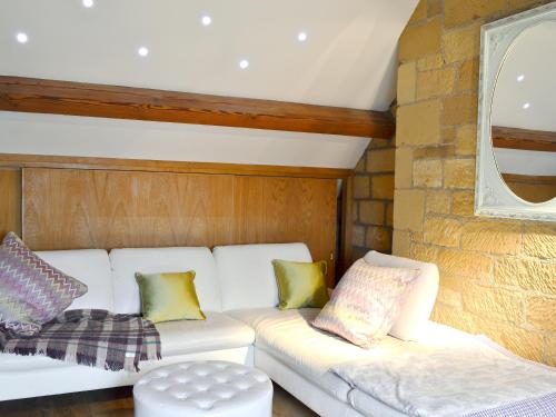 a living room with a white couch and a window at Old Reading Room in Osmotherley