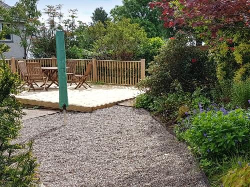 a wooden deck with two chairs and a table at Argyle View in Dunblane