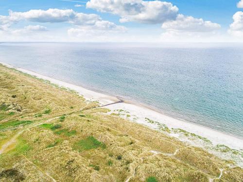 an aerial view of a beach with the ocean at 8 person holiday home in Ålbæk in Ålbæk