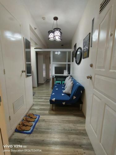 a hallway with a blue bed in a room at Home Escape Tagaytay by Janna 1919 in Tagaytay