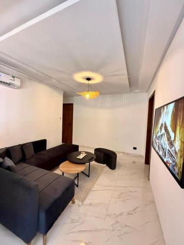 a living room with a couch and a table at Appartement T2- Ain zaghouen in Sidi Daoud
