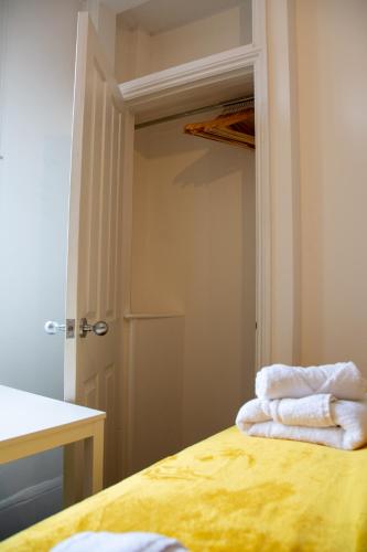 a room with a closet with towels on a bed at 6 BR 4 Bath Central Worcester Sleeps 12 in Worcester