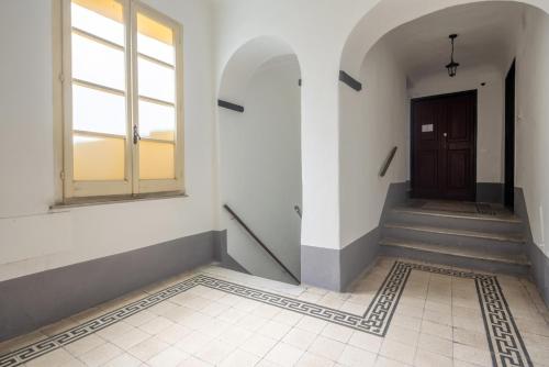 a hallway with a door and stairs in a building at MATTEOTTI ROOMS in Sarzana