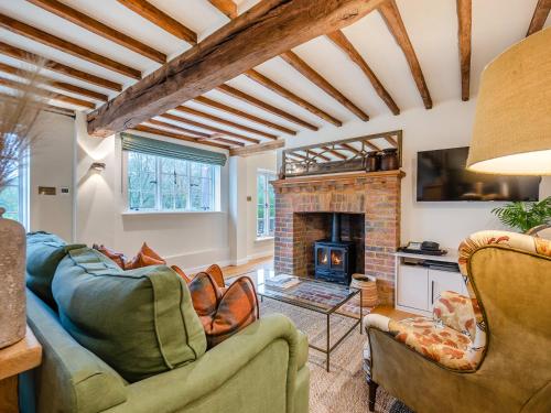 a living room with two couches and a fireplace at Mousehall Oast in Wadhurst
