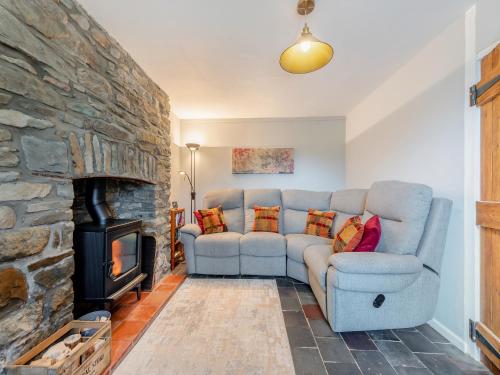 a living room with a couch and a fireplace at West Llwyn - Uk41757 in Rhyd Owen
