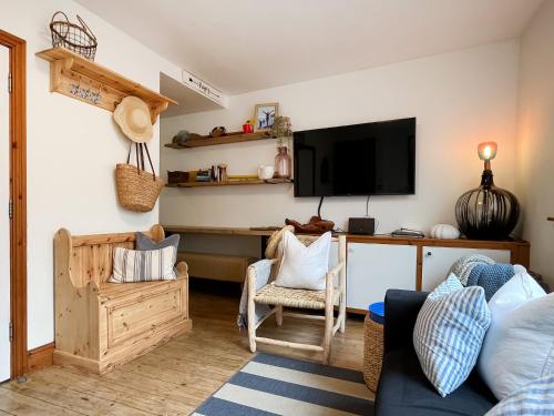 a living room with a couch and a desk with a tv at The Rise in Scarborough