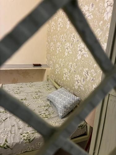 a small bed with a pillow in a room at Prakriti wellness stay in Haridwār