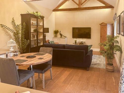 a living room with a couch and a table at Sykelands Cottage in Ravensworth