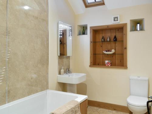a bathroom with a sink and a toilet and a shower at Little Meadow in Dearham