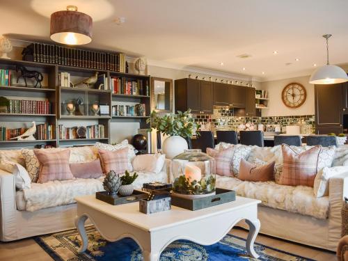 a living room with couches and a table at The Old Stables in Howwood