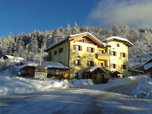 a large building with a sign in the snow at Albergo Aurora in Vignola