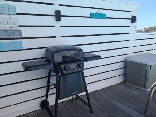 a grill on a deck next to a wall at PERLE DES ANTILLES in Oyster Pond