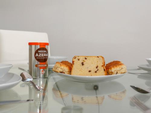 a plate of bread on a table with a bottle of beer at Waterside Lodge Thirteen - Uk11853 in Southowram