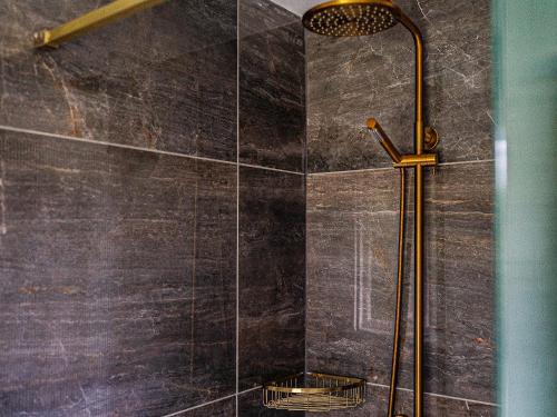 a bathroom with a shower with a glass wall at Moorlands in Chilcompton