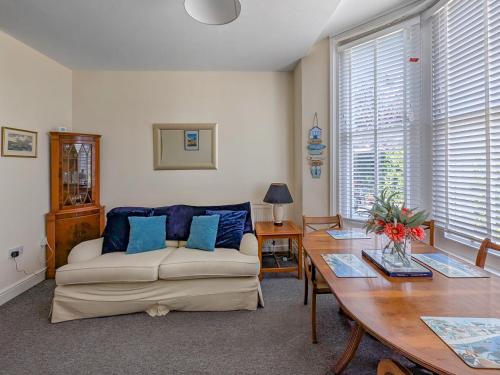 a living room with a couch and a table at Viking Bay Apartment in Broadstairs