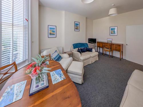 a living room with a table and a couch at Viking Bay Apartment in Broadstairs