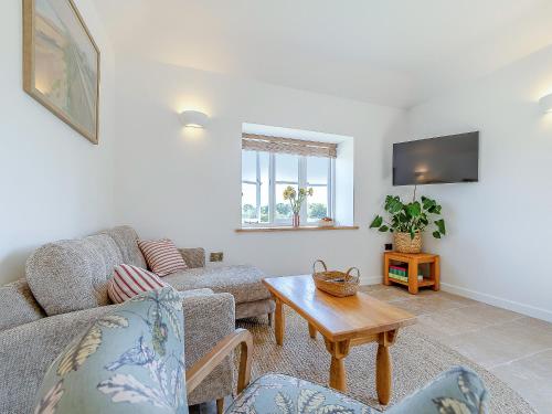 a living room with a couch and a table at Dunnock - Uk50146 in Faversham