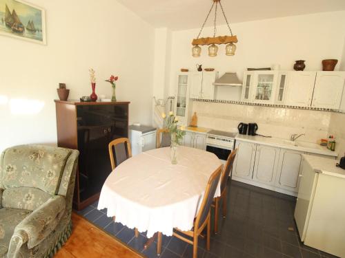 a kitchen with a table and a couch and a table and chairs at Apartment in Starigrad near the Beach in Starigrad-Paklenica