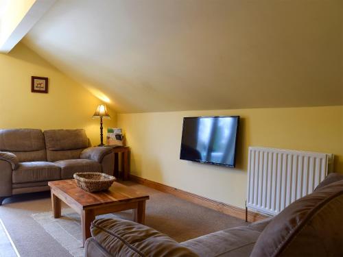 a living room with couches and a flat screen tv at Mange-Tout Maison - Uk32607 in Manton