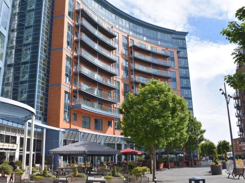 a tall building with tables and chairs in front of it at The Two Bedroom Balcony View in Portsmouth