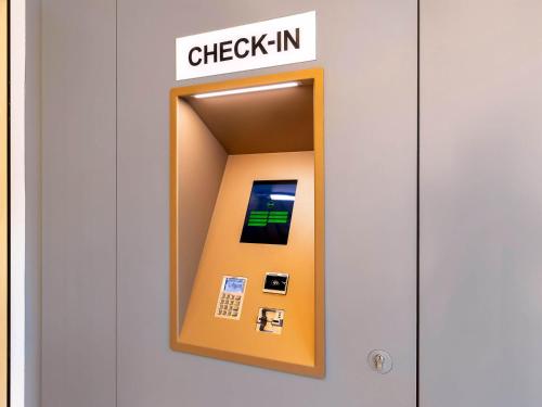 an elevator with a check in sign on a door at B&B Hotel Oberhausen am Centro in Oberhausen