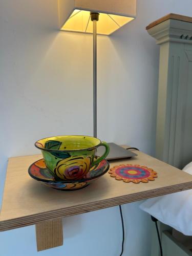 a bowl sitting on a table next to a lamp at Crown Lodge, Great Glemham in Saxmundham