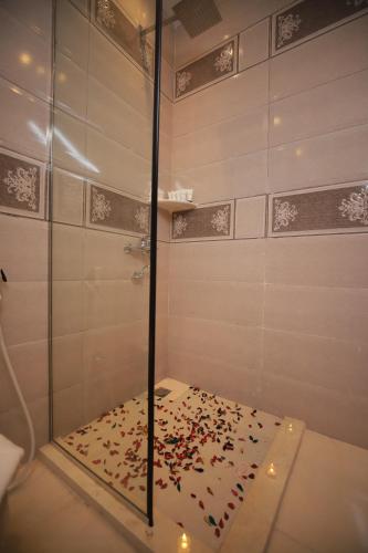 a shower with confetti on the floor in a bathroom at Happy Day Pyramids View Hotel in Cairo