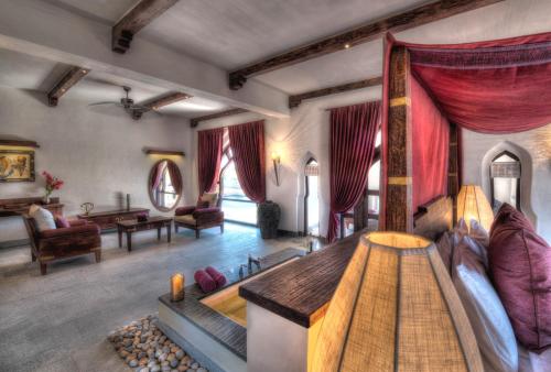 a living room with a couch and a table at Evolve Back Hampi in Hampi