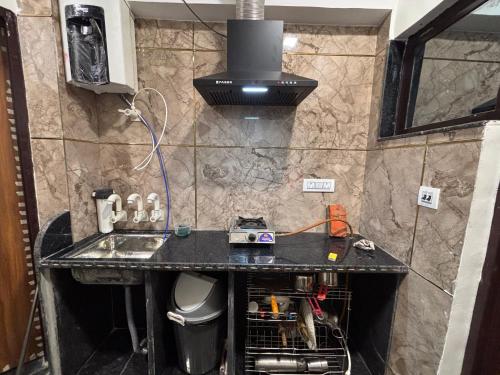 a kitchen with a sink and a counter top at Rukmani Home Stay in Mathura