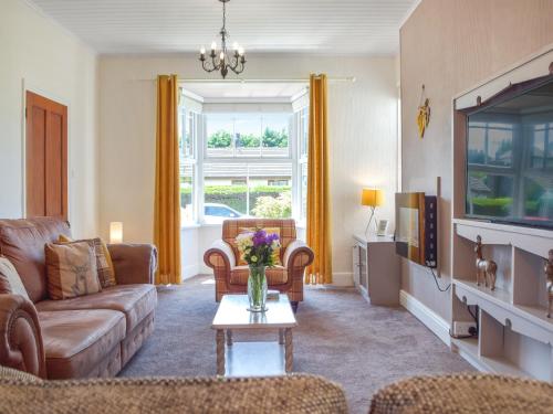 a living room with a couch and a table at Ferwig in New Quay
