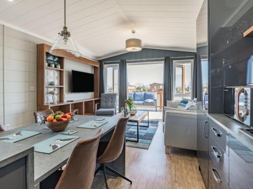 a kitchen and living room with a table and chairs at Coastal Retreat - Uk37722 in Ingoldmells