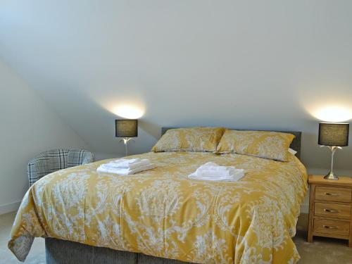 a bedroom with a bed with two towels on it at The Steading in Montrose