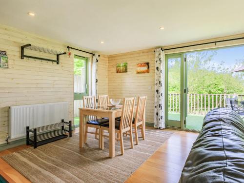 a dining room with a table and chairs at Primrose Lodge in Holsworthy