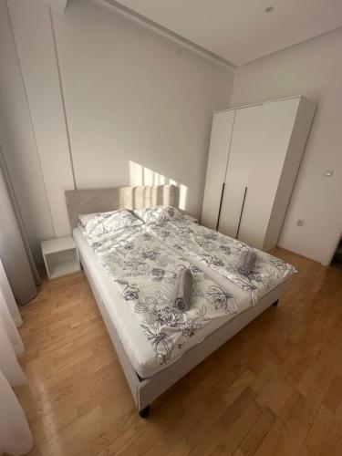a bedroom with a bed in a room at City Center Apartment in Zrenjanin