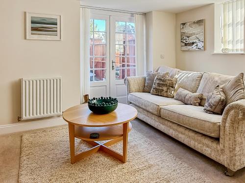 a living room with a couch and a table at The Police Station - Uk45642 in Silloth
