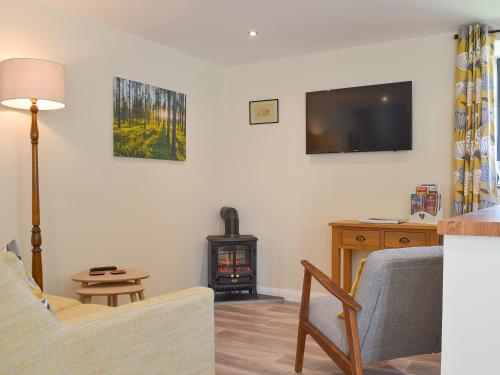 a living room with a couch and a wood stove at The Stable in Bridgwater