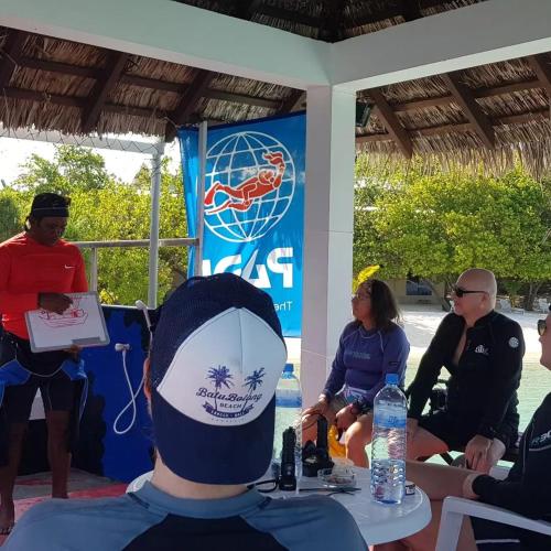 a group of people sitting around a table at Lagoon View in Bodufolhudhoo
