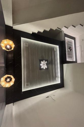 a wall with two lights and a mirror on it at Rukmani Home Stay in Mathura