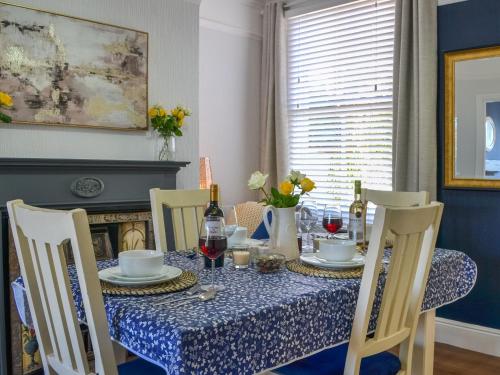 a dining room table with a blue and white table cloth at Mere Walk in Hornsea