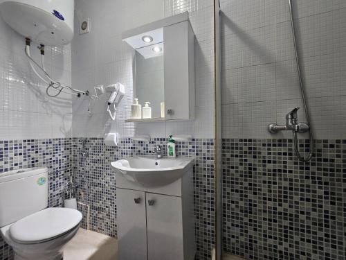 a bathroom with a toilet and a sink and a shower at Buenavista CaboNegro in Cabo Negro