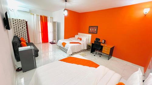 Кровать или кровати в номере Hôtel résidence Teranga confort