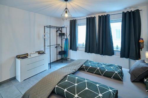 a bedroom with a bed and a dresser and a window at Wohlfühlnest in Sankt Leon-Rot