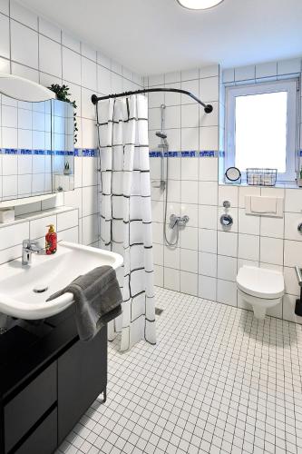 a white bathroom with a sink and a toilet at Wohlfühlnest in Sankt Leon-Rot